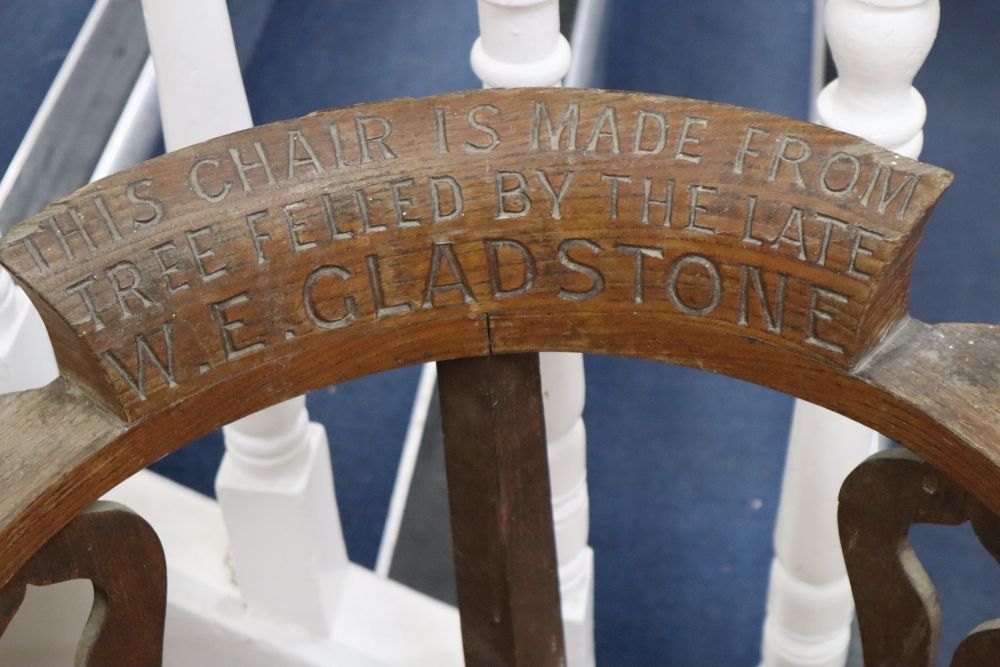 An early 20th century oak framed corner chair c.1900, inscribed This Chair is made from tree felled by the late W.E. Gladstone